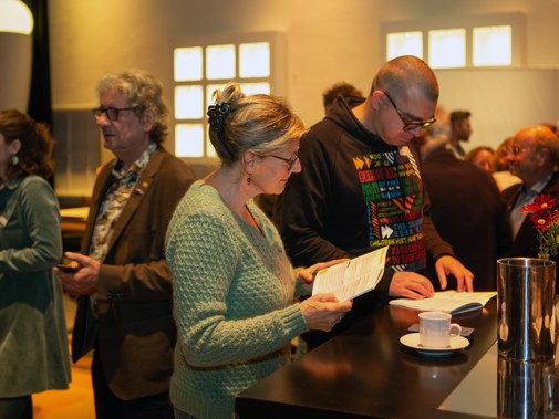 De dag bestond uit een vol programma. Bezoekers bekijken het programma in het programmaboekje. Foto: Floris Scheplitz